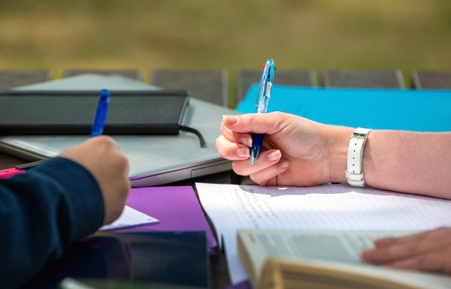 Woman working on laptop reviewing financial planning documents