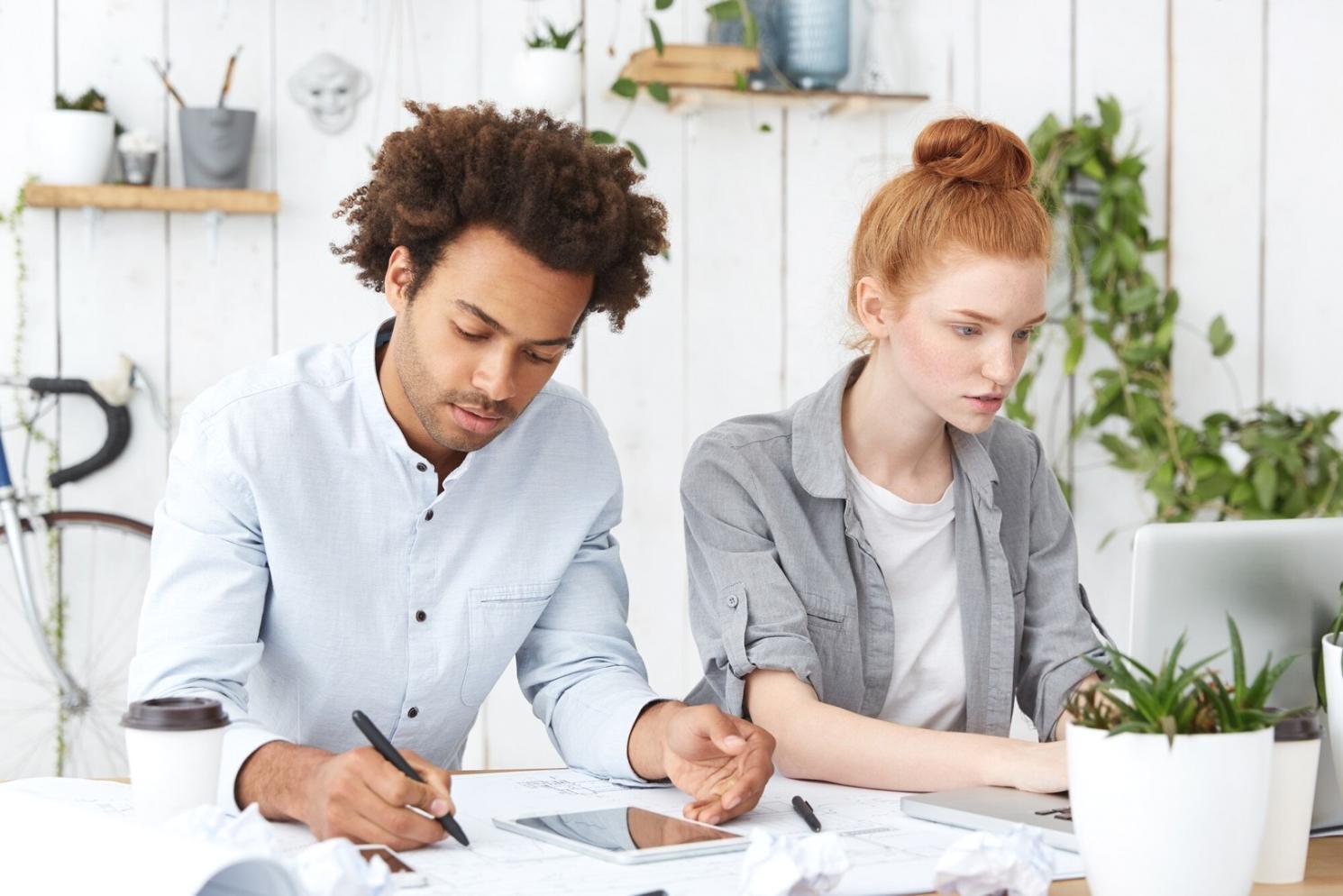 Team member reviewing financial documents with client at office desk