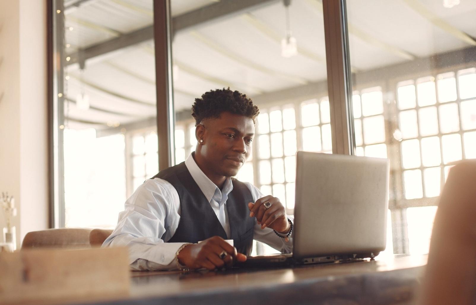 Person reviewing financial documents at desk with calculator and notes